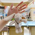 Close-up of plush bunny keychain with long ears and a mini white carrot shoulder bag - Gold Metal Buckle / Brown