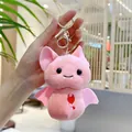 Close-up of pink plush bat keychain with embroidered devil heart and metal ring - Pink (Gold Clasp)