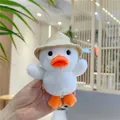 Close-up of cute white plush duck with straw hat held in hand as a soft keychain - White Duck With Chain / White / 12cm