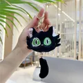 Detail of black plush cat keychain with green embroidered eyes and gold hardware - Black / Gold D-Ring Buckle