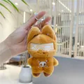 Detailed view of hand-held brown plush cat keychain with goggles and skull motif - Hanging Chain / Brown