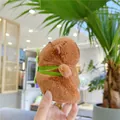 Brown capybara plush toy with a green backpack accessory shown in a hand - Single Layer Turtle Backpack Style (11cm) / Plain Chain