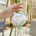 Detail of white and green plush cat keychain with golden clasp held in hand - Gold Clasp / Green