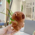 Detail of cute Capybara plush keychain with green dinosaur backpack and soft brown fur - Turtle Backpack Style (10cm) / Plain Chain