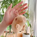 Plush brown Capybara keychain with rose gold metal ring shown in hand for size - Basic Style (Gold Clasp)