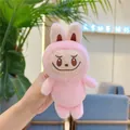 Close-up of small pink Labubu plush doll with detailed teeth embroidery held in hand - Style Without Chain / Pink