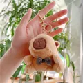Cute Capybara plush keychain with black and white checkered bow tie on a metal clip - Brown Bowtie Style (Gold Clasp)