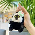 Detailed plush white-faced monkey keychain with hand-woven flower detail held by hand - Hanging Chain / Green