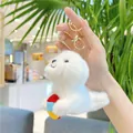 Close-up of a cute white plush seal charm holding a colorful ball with gold keychain - 12cm / Gold Buckle Style / White