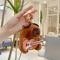 Cute brown capybara plush keychain wearing a black hat and holding a guitar decoration - Orange Guitar Style (11cm) / Gold Clasp