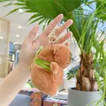 Brown plush capybara keychain with green backpack and gold metal clip held in hand - Single Layer Turtle Style (11cm) / Gold Clasp
