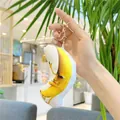 Cartoon moon plush keychain with golden lobster clasp shown held in hand - Banana Style With Sounder / 13cm / Funny Banana (Gold Hook)