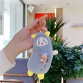 Close-up of gray fuzzy monster plush keychain with rainbow embroidery and orange bag - With Water Bottle Style / Gray / Hanging Chain