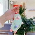 Close-up of a green plush monster keychain with RAINBOW embroidery and blue accessory - With Water Bottle Style / Green / Hanging Chain