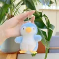 Close-up of a blue plush penguin keychain hanging by a gold chain in a soft background - Hanging Chain / Blue