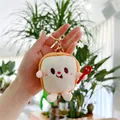 Gros plan d'un porte-clés en peluche pain de mie avec visage brodé et fermoir doré - Pain Grillé (Boucle Dorée) / 8 cm - 10 cm