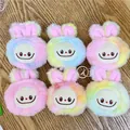 Close-up of six colorful plush monster pendants with golden keychains on a wood surface - Colorful Tie Dye / No Chain