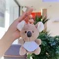 Detail of cute koala plush keychain with blue striped bib and silver metal ring - Brown with Bib