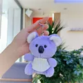 Detail of purple koala plush keychain with green striped bib and metal ring hanging - Purple with Bib