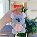 Close-up of plush koala keychain with orange striped bib and silver metal ring - Gray with Bib