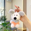 Close-up of a white plush dog keychain wearing an orange sweater with a play dog print - Plain Chain / Orange