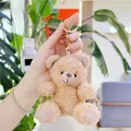Close-up of brown curly plush teddy bear keychain with golden metal ring and lobster clasp - Gold Clasp / Tan / 11cm
