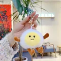 Close-up of cute poached egg plush keychain with smiling face and golden metal clasp - 11cm / Egg Boy Gold Buckle