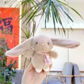 Close-up of a plush rabbit doll with floral patterned ears held in a hand - Chain Style / Brown / Approx. 13cm