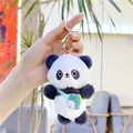 Detail of cute panda plush keychain with soft fur and a green dinosaur crossbody bag - Panda with Dinosaur Backpack (Gold Hook) / Approx. 11cm / Black