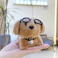 Close-up of cute plush dog keychain with black round glasses and golden bell collar - Brown Body