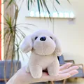 Close-up of a palm-sized beige plush puppy keychain made of soft polyester fiber - Hanging Chain / Khaki