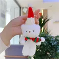 Detail view of a white plush Christmas bear keychain with red knitted hat and striped scarf - Gold Lobster Clasp / Bleached White Red Green Scarf