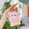 Close-up of pink fluffy teddy bear plush keychain with soft fur and silver metal ring - Pink