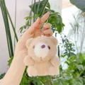 Close-up of soft light brown plush bear pendant with silver metal keychain and furry texture - Khaki