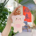 Pink plush pig keychain with red checkered bib and golden clasp on a handbag - Pink Pig / Gold Metal Buckle