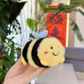 Close-up of fuzzy bee plush keychain with soft yellow and black stripes and metal link - Plain Chain / Blue Wings