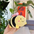 Close-up of cute plush bee keychain featuring soft yellow and black stripes with pink wings - Plain Chain / Pink Wings