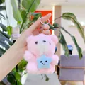 Detailed close-up of a pink plush bear holding a blue star with a smiley face - Plain Chain / Pink with Star