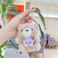 Close-up of a plush bear keychain holding a purple star, shown in hand for scale - Plain Chain / Khaki with Star