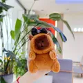 Detail of cute Capybara plush keychain with a black bow in a warm indoor setting - Plain Chain / Black Bow
