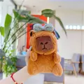 Detail of Capybara plush keychain with a blue plaid bow tie in a cafe setting - Plain Chain / Blue Bow