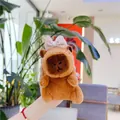 Close-up of plush Capybara earphone case with a checkered bow tie decoration - 11cm Standard Chain / Pink Bowknot