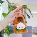 Close-up of plush capybara keychain holding a pink peach with gold lobster clasp - Holding Peach - Gold Clasp