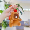 Close-up of cute brown capybara plush keychain with bubble design and red fruit detail - Red Apple - Bubble Style (Golden Hook)