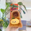 Close-up of a cute capybara plush keychain holding a yellow lemon with a smiling face - Holding Mango - Chain