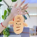 Close-up of cute cartoon baguette plush keychain with soft yellow texture and golden clip - 13cm / Gold Lobster Clasp / Yellow