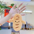Close-up of cute plush baguette keychain with smiling embroidery and metal clasp - 13cm / Silver Hanging Chain / Yellow