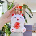Close-up of white plush lucky cat keychain with Pingan embroidery and gold clasp - White Gold Buckle