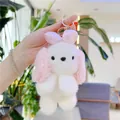 Portachiavi peluche cucciolo con orecchie lunghe e fiocco rosa in un giardino luminoso - Rosa Con Fermaglio Dorato