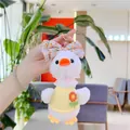 Close-up of cute plush duck keychain with pink lace collar and orange floral bow - Gold Clasp / 19cm / Yellow